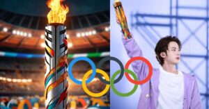 A man holding torch of olympics.